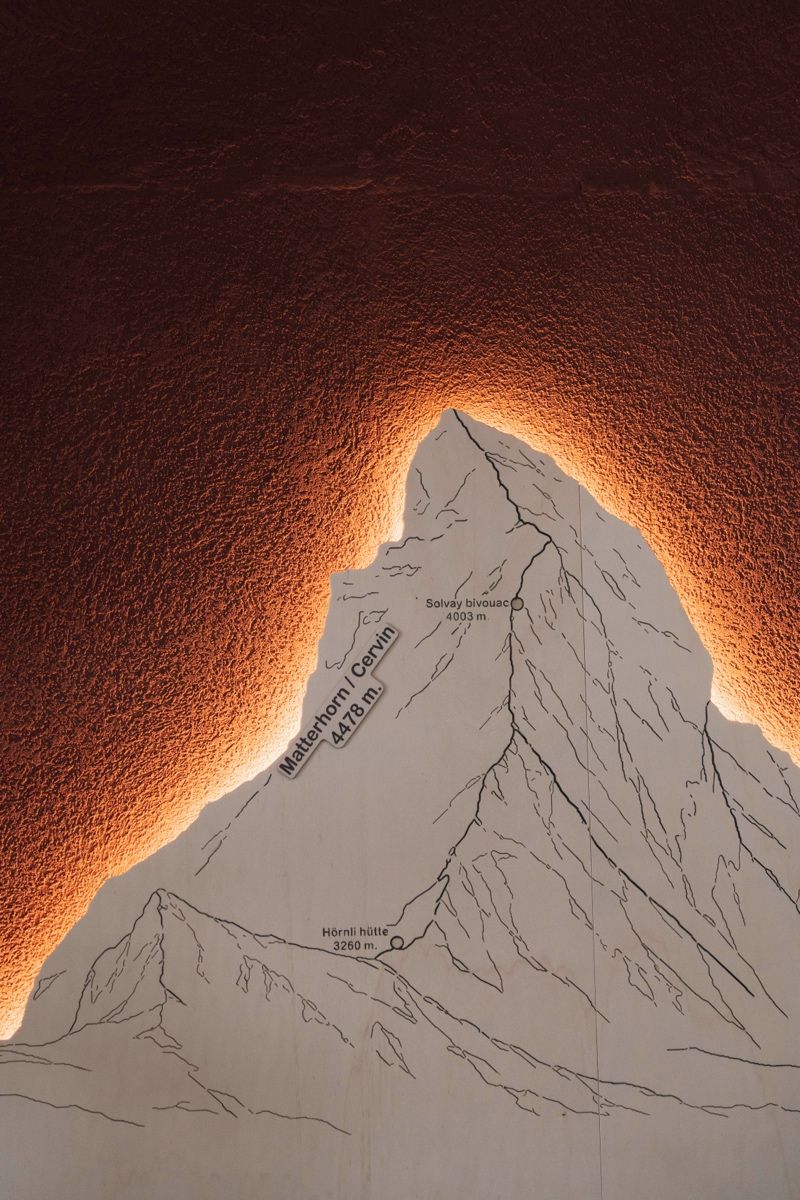 Hinterleuchtete Bergsilhouette an der roten Wand